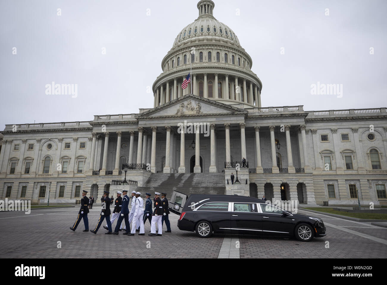 Joint service members of a military casket team carry the casket of Senator John McCain from the US Capitol to a motorcade that will ferry him to a funeral service at the National Cathedral in Washington, DC, on September 1, 2018. McCain died August 25, 2018 from brain cancer at his ranch in Sedona, Arizona, USA. He was a veteran of the Vietnam War, served two terms in the US House of Representatives, and was elected to five terms in the US Senate. McCain also ran for president twice, and was the Republican nominee in 2008.   Photo by Jim Lo Scalzo Stock Photo