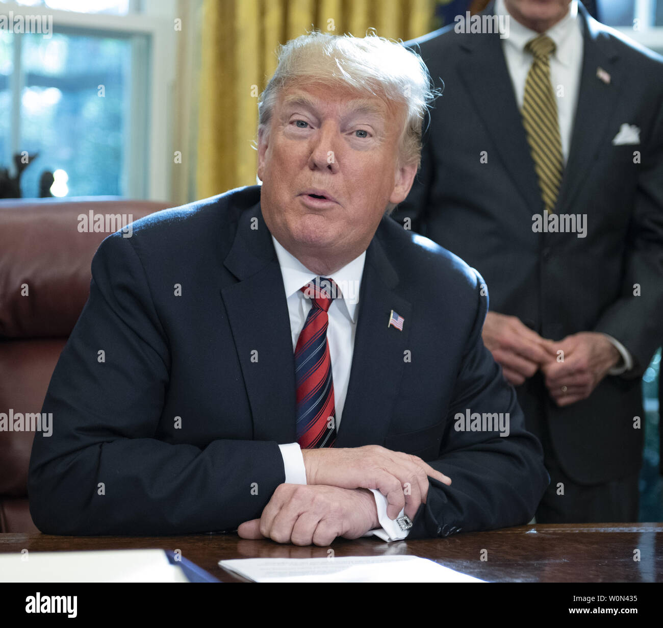 United States President Donald J. Trump signs S.3021, America's Water Infrastructure Act of 2018 in the Oval Office of the White House in Washington, DC on Tuesday, October 23, 2018.  After signing the bill, the President took questions from the pool on the caravan and Saudi Arabia.      Photo by Ron Sachs/UPI Stock Photo