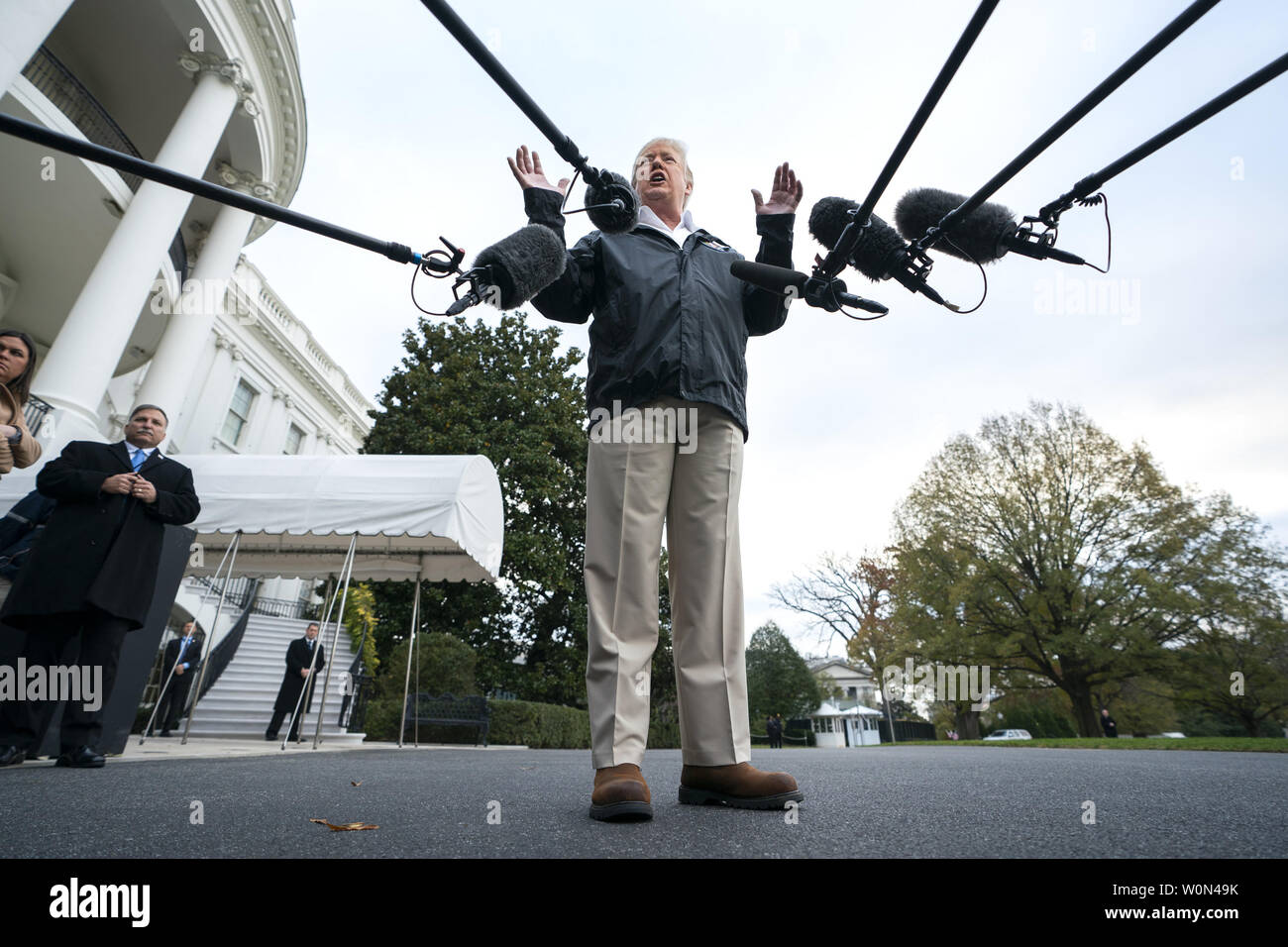 U.S. President Donald Trump speaks to the media before he departs the White House for California, where he is scheduled to view damage from that state's wildfires, in Washington, DC, on November 17, 2018. Seventy-four people have been killed and more than 1,000 people are missing due to multiple devastating fires across the state. The President spoke about the investigation into Jamal Khashoggi's murder, the Mueller investigation, and the migrant caravan approaching the southern border.   Photo by Jim Lo Scalzo/UPI Stock Photo