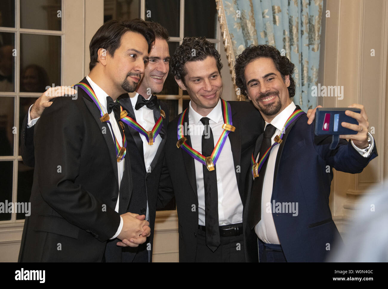 Hamilton co-creators Lin-manuel Miranda, Andy Blankenbuehler, Thomas Kail, and Alex Lacamoire, four of the recipients of the 41st Annual Kennedy Center Honors, pose for a selfie prior to sitting for a group photo following a dinner hosted by United States Deputy Secretary of State John J. Sullivan in their honor at the US Department of State in Washington, D.C. on Saturday, December 1, 2018.  The 2018 honorees are: singer and actress Cher; composer and pianist Philip Glass; Country music entertainer Reba McEntire; and jazz saxophonist and composer Wayne Shorter. This year, the co-creators of H Stock Photo