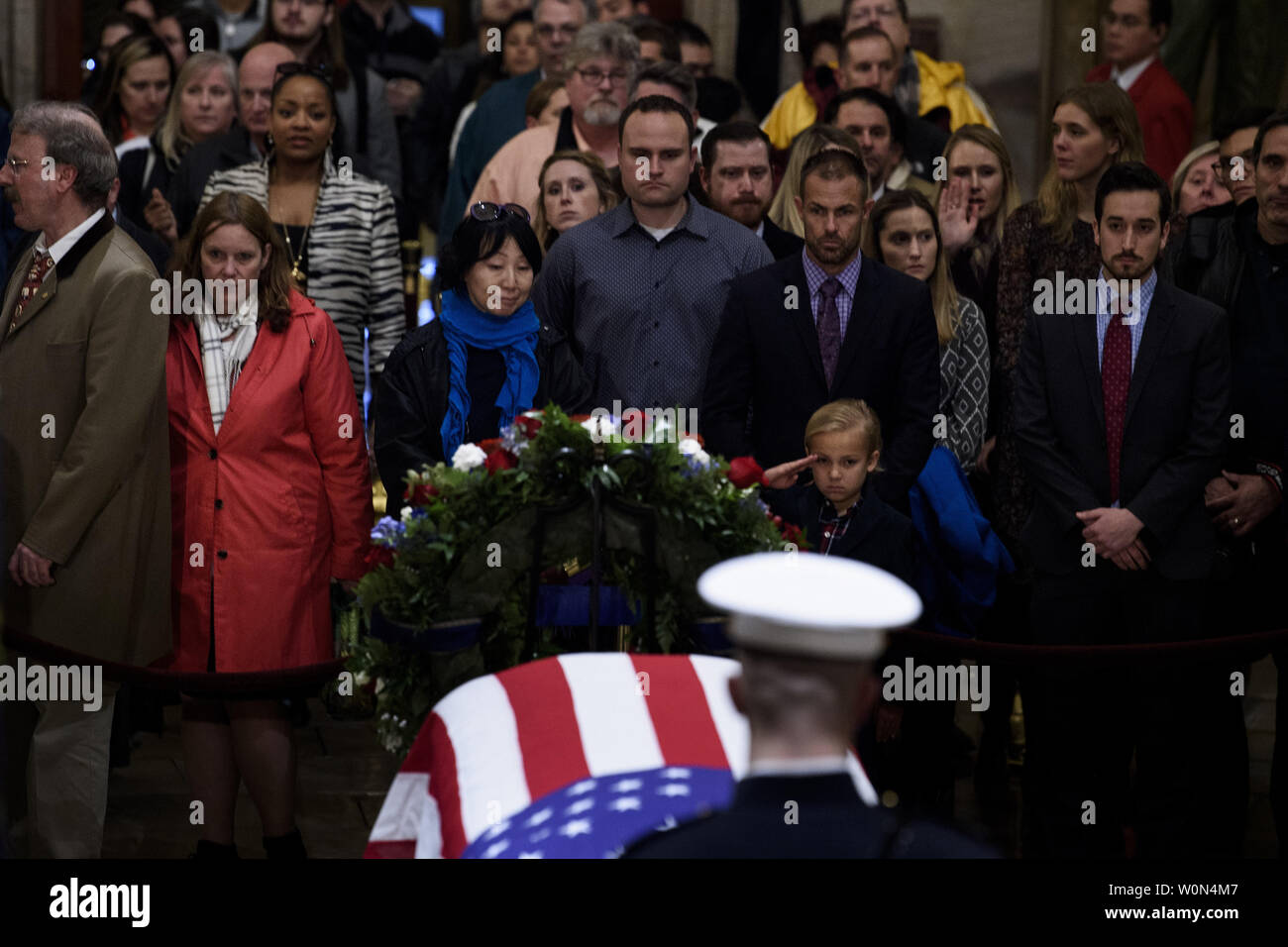 Stephen G. Leighton Jr. salutes while paying respects with his father  Stephen G. Leighton Sr. as the remains of former US President George H. W. Bush lie in state in the US Capitol's rotunda December 3, 2018 in Washington, DC.     Photo by Brendan Smialowski/UPI Stock Photo