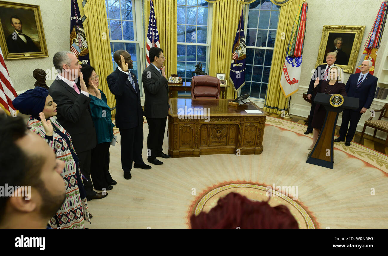Five people take the oath of citizenship from United States Secretary of Homeland Security (DHS) Kirstjen Nielsen during a ceremony hosted by U.S. President Donald J. Trump in the Oval Office of the White House in Washington, DC on Saturday, January 19, 2019.  U.S. Vice President Mike Pence looks on.   Photo by Ron Sachs/UPI Stock Photo