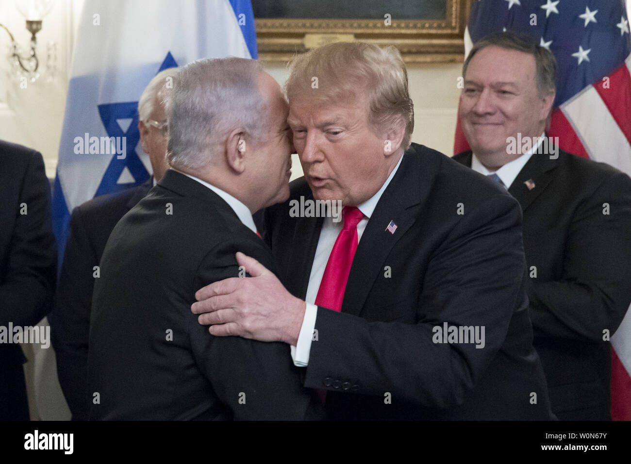 President Donald Trump is hugged by Israeli Prime Minister Benjamin Netayahu  after Trump signed an order recognizing the Golan Heights as Israeli territory  in the Diplomatic Reception Room of the White House in Washington, DC on March 25, 2019.     Photo by Michael Reynolds/UPI Stock Photo