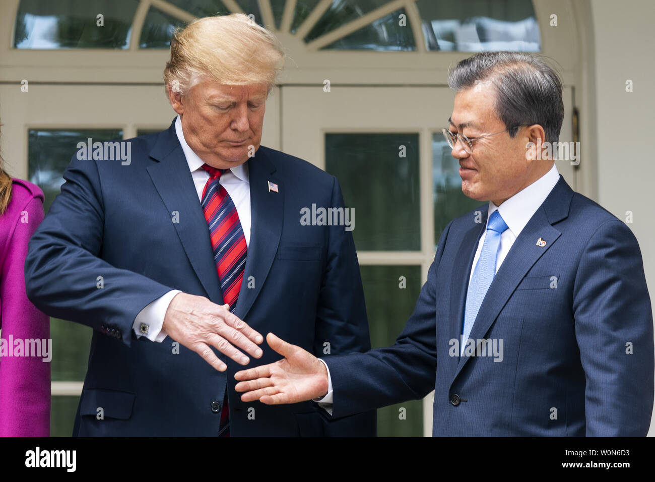 US President Donald J. Trump (L) and Korean President Moon Jae-in (R) shake hands in the Colonnade of the White House in Washington on April 11, 2019. President Moon is expected to ask President Trump to reduce sanctions on North Korea in an attempt to jump start nuclear negotiations between North Korea and the US.  Photo by Jim Lo Scalzo/UPI Stock Photo