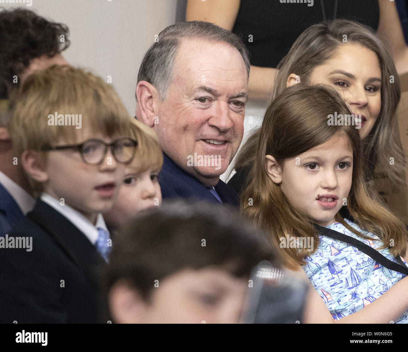Former Governor Mike Huckabee (Republican of Arkansas) holds his grandchildren Huck, George, and Scarlett, as his daughter, White House Press Secretary Sarah Huckabee Sanders, takes questions from children  of White House staff and journalists in observance of “Take Our Daughters and Sons to Work Day” in the Brady Press Briefing Room of the White House in Washington, DC on April 25, 2019. Photo by Ron Sachs/UPI Stock Photo
