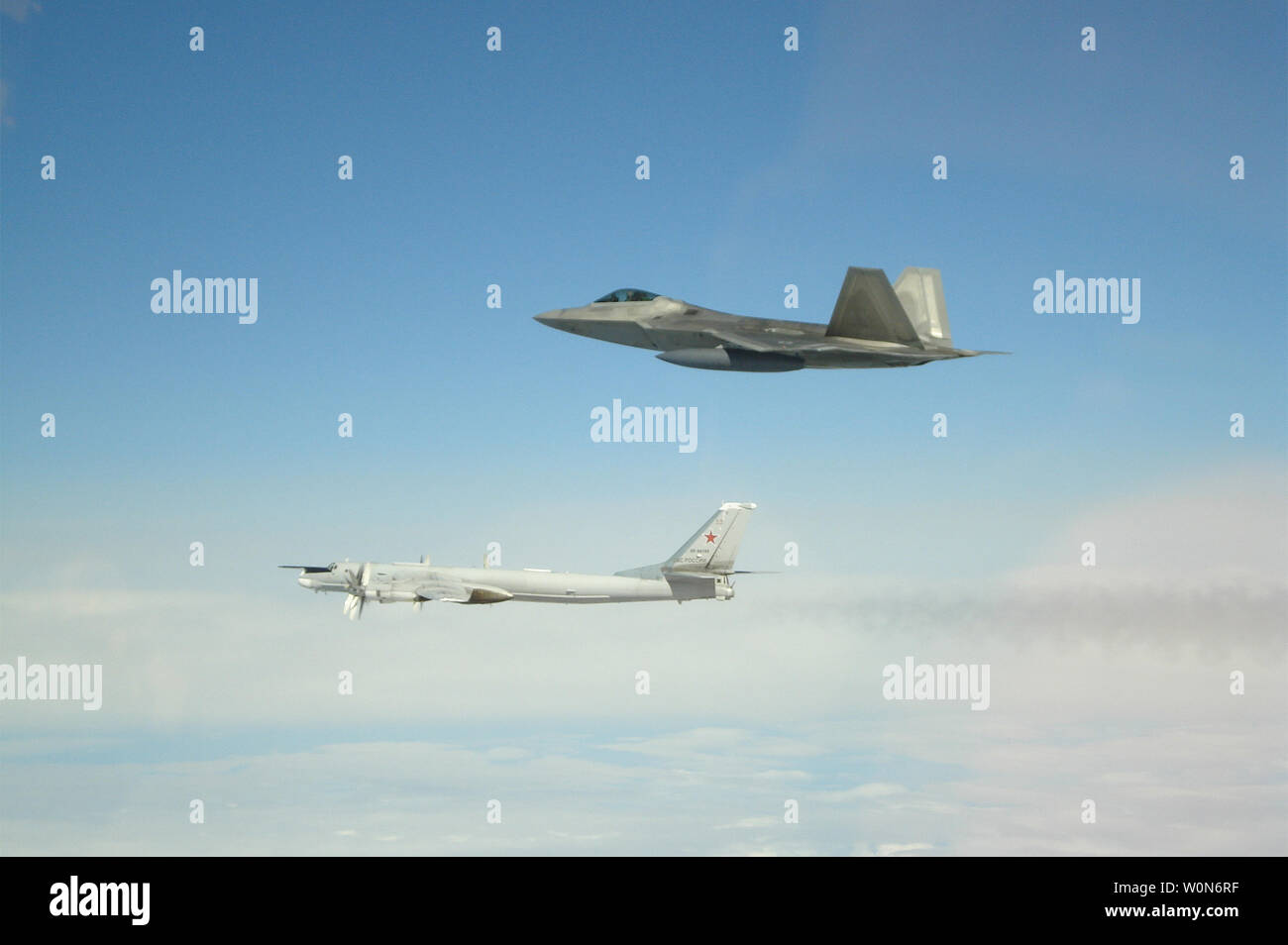 In this photo by NORAD an American F-22 flies along side a Russian Tupolev Tu-95 bomber entering the Alaskan Air Defense Identification Zone (ADIZ) on May 20, 2019.  Two pairs of F-22s, along with an E-3 Airborne Early Warning and Control System, from North American Aerospace Defense Command (NORAD) positively identified and intercepted a total of four Tupolev Tu-95 bombers and two Su-35 fighters the ADIZ.    UPI Stock Photo