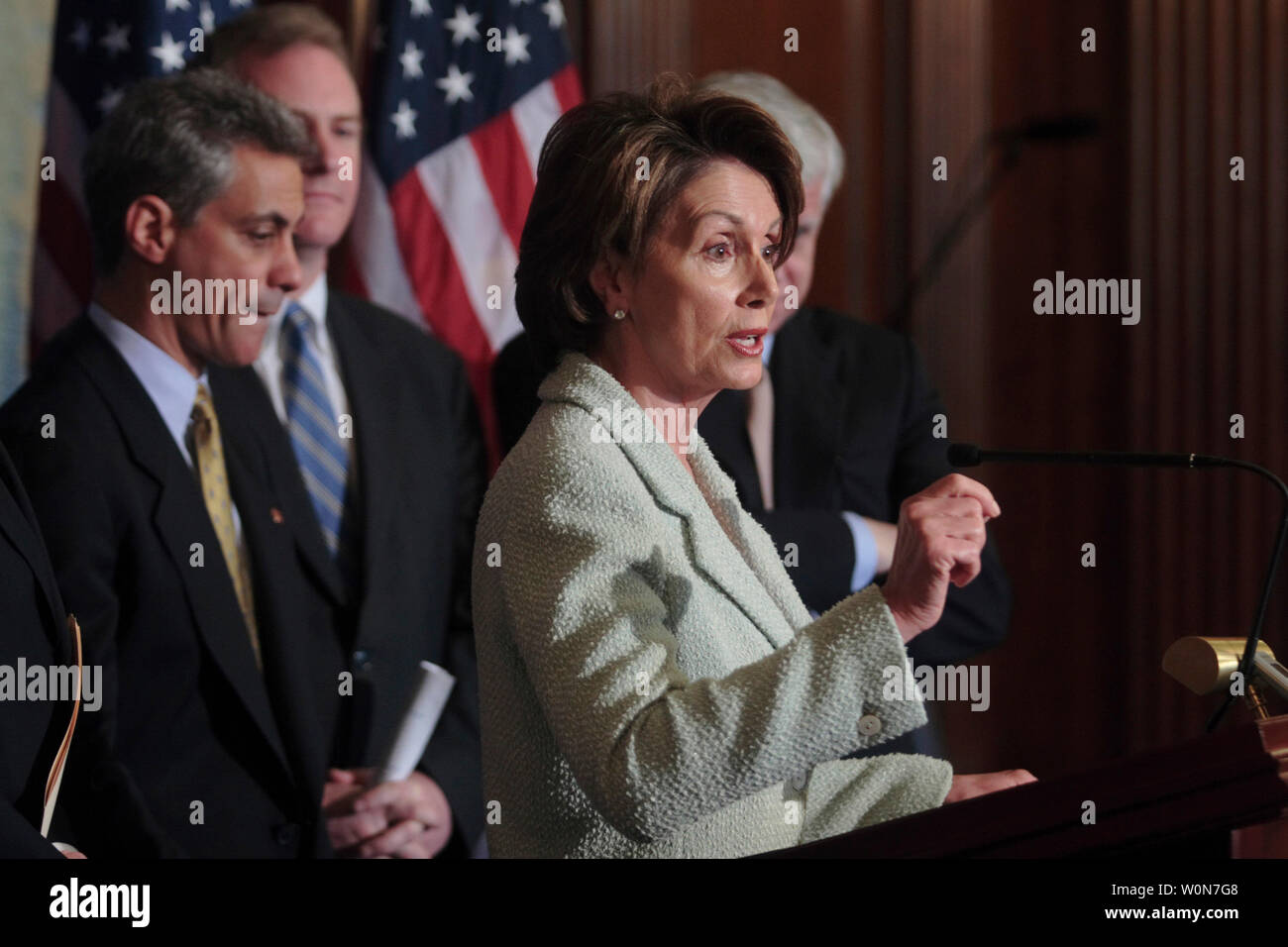 House Speaker Nancy Pelosi (D-CA) speaks to reporters marking first 100 days of Democrat run Congress on Capitol Hill in Washington, March 28, 2007. Rahm Emanuel (D-IL) (L) listens.  (UPI Photo/ Kamenko Pajic) Stock Photo