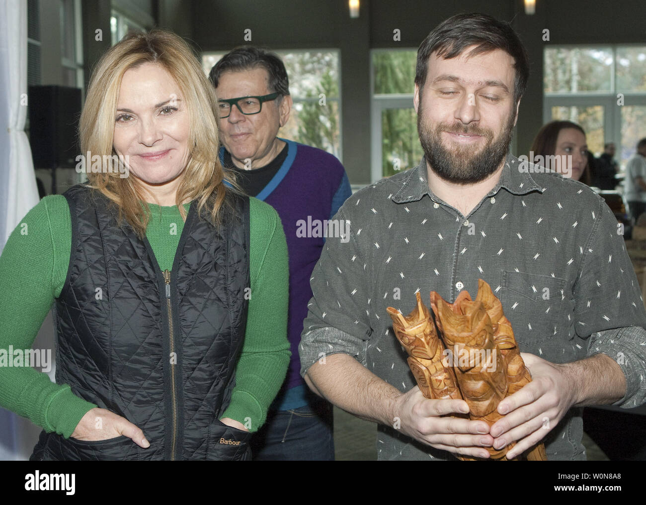 Actress Kim Cattrall and Quebec director Maxime Giroux holding his film's four awards leave the white carpet at the Awards Brunch during the 2014 Whistler Film Festival in Whistler, British Columbia, December 7, 2014. Giroux's film 'Felix and Meira' won the Borsos Award for Best Canadian Feature, Best Screenplay and Best Borsos Director Awards, while the film's lead Hadas Yaron won the Best Performance Award.   UPI/Heinz Ruckemann Stock Photo