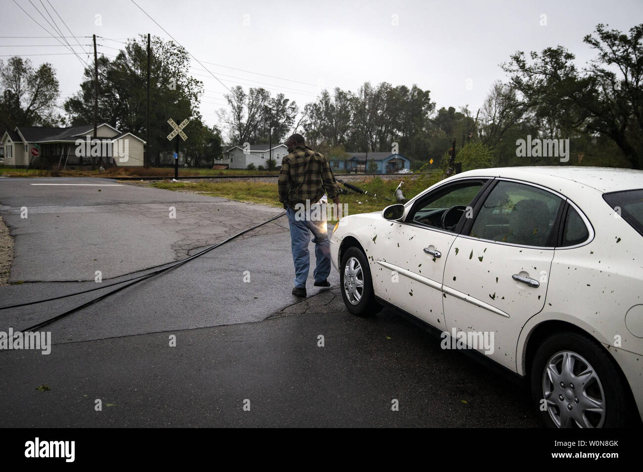 A man determines if he can drive over fallen power lines, as Hurricane