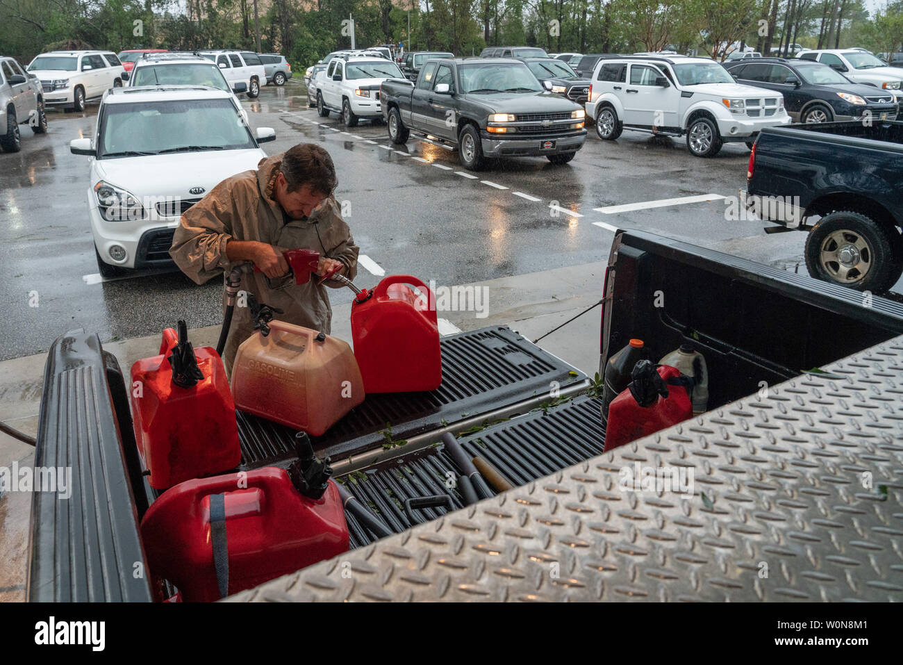 Winston Garrett, who waited in line for three hours, pumps gas at a Costco gas station following tropical storm Florence September 16, 2018 in Wilmington, North Carolina. Florence, now a tropical storm is continuing to dump rain on North and South Carolina.     Photo by Ken Cedeno/UPI Stock Photo