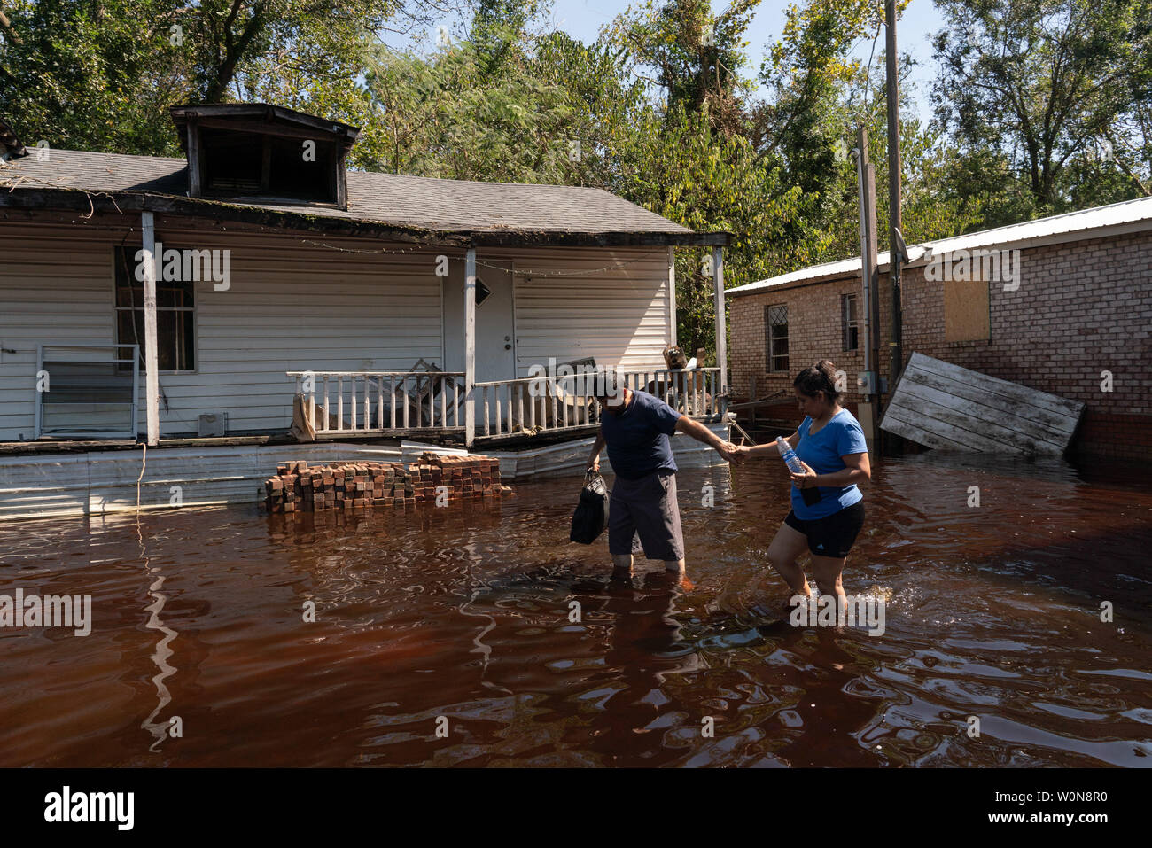 Ignacio and Sylvia Bautista hold hands after checking out their property following Hurricane Florence, now tropical depression September 19, 2018 in Beulaville, North Carolina. Florence, is continuing to dump rain on North and South Carolina and the Cape Fear River Valley and other rivers will rise breaking record flood levels.     Photo by Ken Cedeno/UPI Stock Photo