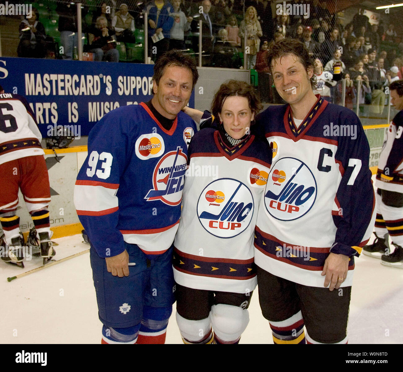 A 20-year NHL veteran, Doug Gilmore (L) with singer Sarah Harmer, nominated for Adult Alternative Album of the Year with 'All of Our Names' and Jim Cuddy of the band Blue Rodeo nominated for Music DVD of the Year, after a charity hockey game, during the 2005 Canadian Juno Music Awards in Winnipeg, April 1,2005.        (UPI Photo / Heinz Ruckemann) Stock Photo