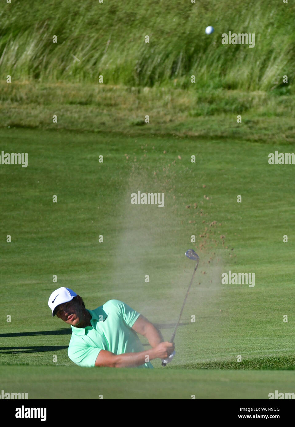 Brooks Koepka blasts from the No. 14 bunker during the final round of the 117th U.S. Open golf tournament at Erin Hills golf course on June 18, 2017, in Erin, Wisconsin. Photo by Kevin Dietsch/UPI Stock Photo