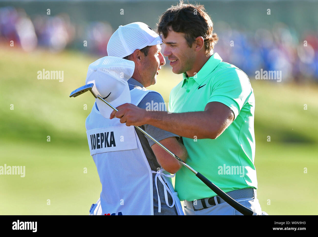 Brooks Koepka hugs caddie Richard Elliott after winning the 117th U.S. Open golf tournament at Erin Hills golf course on June 18, 2017, in Erin, Wisconsin. Photo by Kevin Dietsch/UPI Stock Photo