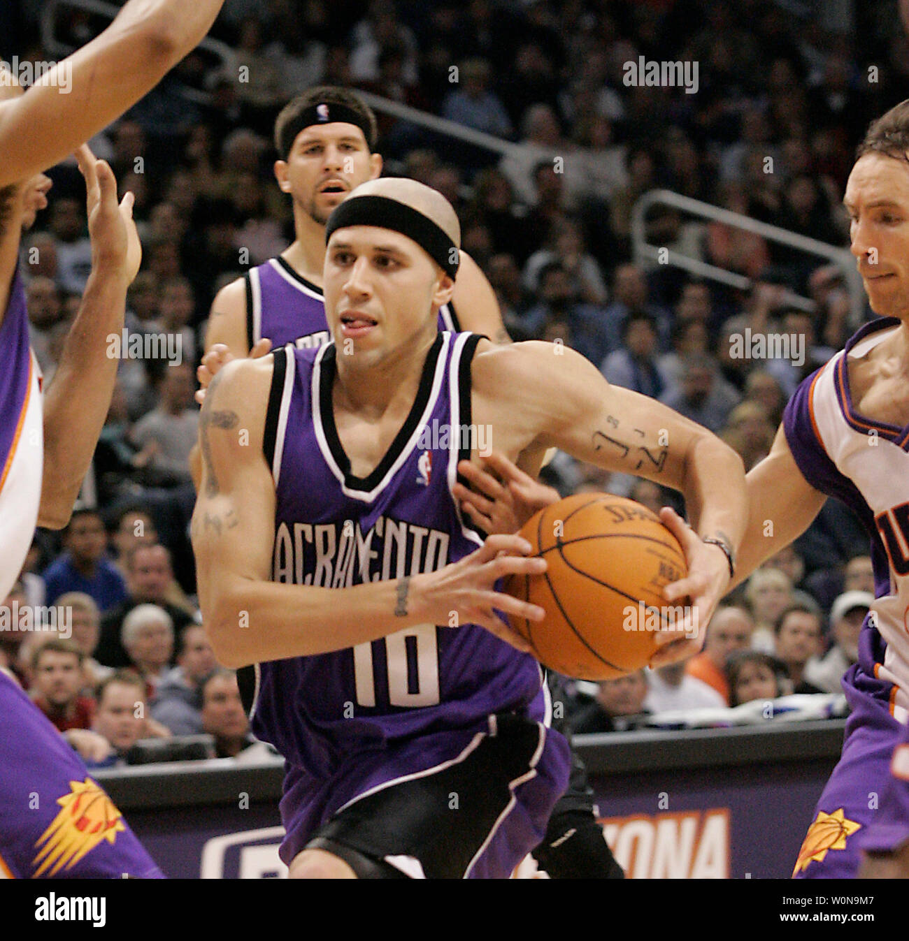 Phoenix Suns Steve Nash reaches in and slaps the ball away from Sacramento Kings Mike Bibby on Nov. 13, 2004 in Phoenix, AZ.    (UPI Photo/Will Powers) Stock Photo