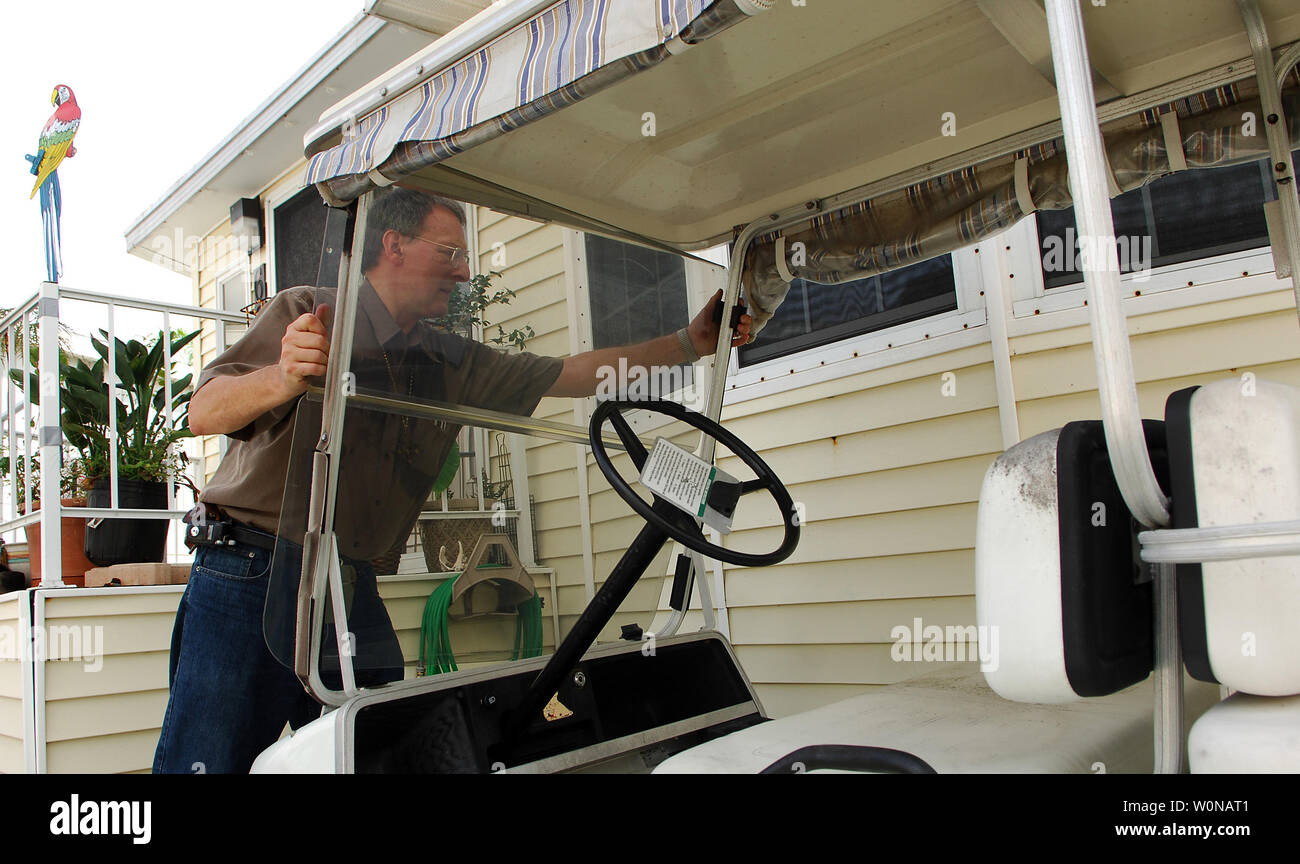 Pastor Robert E. Palisin, 67, secures his golf cart in preparation for Hurricane Wilma in Port St. Lucie, Florida on, October 23, 2005. The category two hurricane is expected to come ashore on the southwest coast of Florida Monday morning. (UPI Photo/Steve Mitchell) Stock Photo