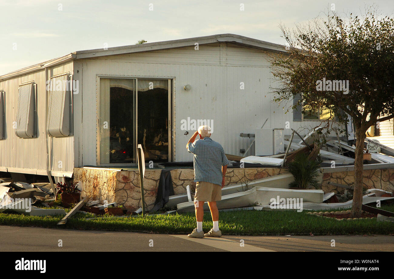 A resident looks at the damage from Hurricane Wilma at a mobile home on October  24, 2005, in Stuart, Florida. The category 2 storm with 105 mph winds moved off the coast between Martin and Palm Beach counties. At its peak, the storm was a category 3 with 125 mph winds. (UPI Photo/Steve Mitchell) Stock Photo