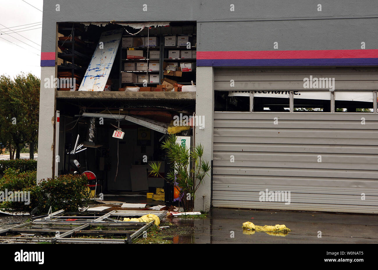 A Brake Repair Shop Stands Open With Its Front Door Ripped Off