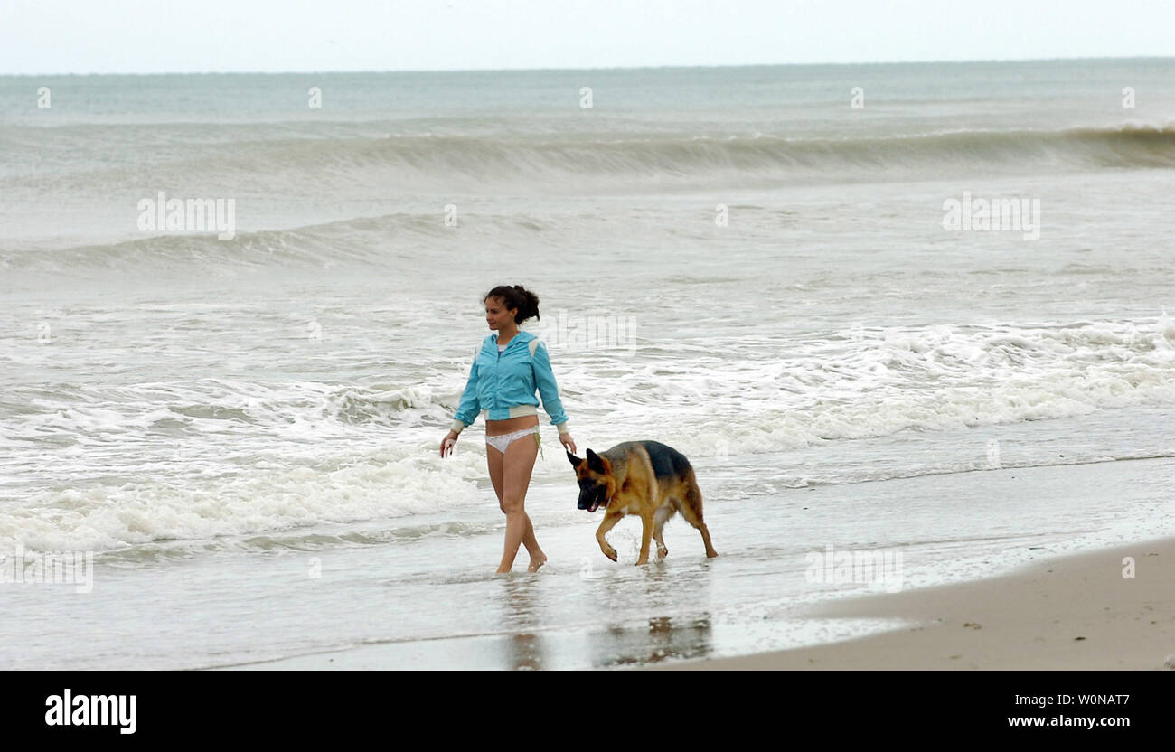 Kate Kreisberg of Boca Raton, Florida and her dog  Hunter walk the beach in Boca Raton, looking for sea shells after Hurricane Wilma on October 24, 2005. The category 2 storm with 105 mph winds, moved off coast between Martin and Palm Beach counties. At its peak, the storm was a category 3 with 125 mph winds. (UPI Photo/Steve Mitchell) Stock Photo