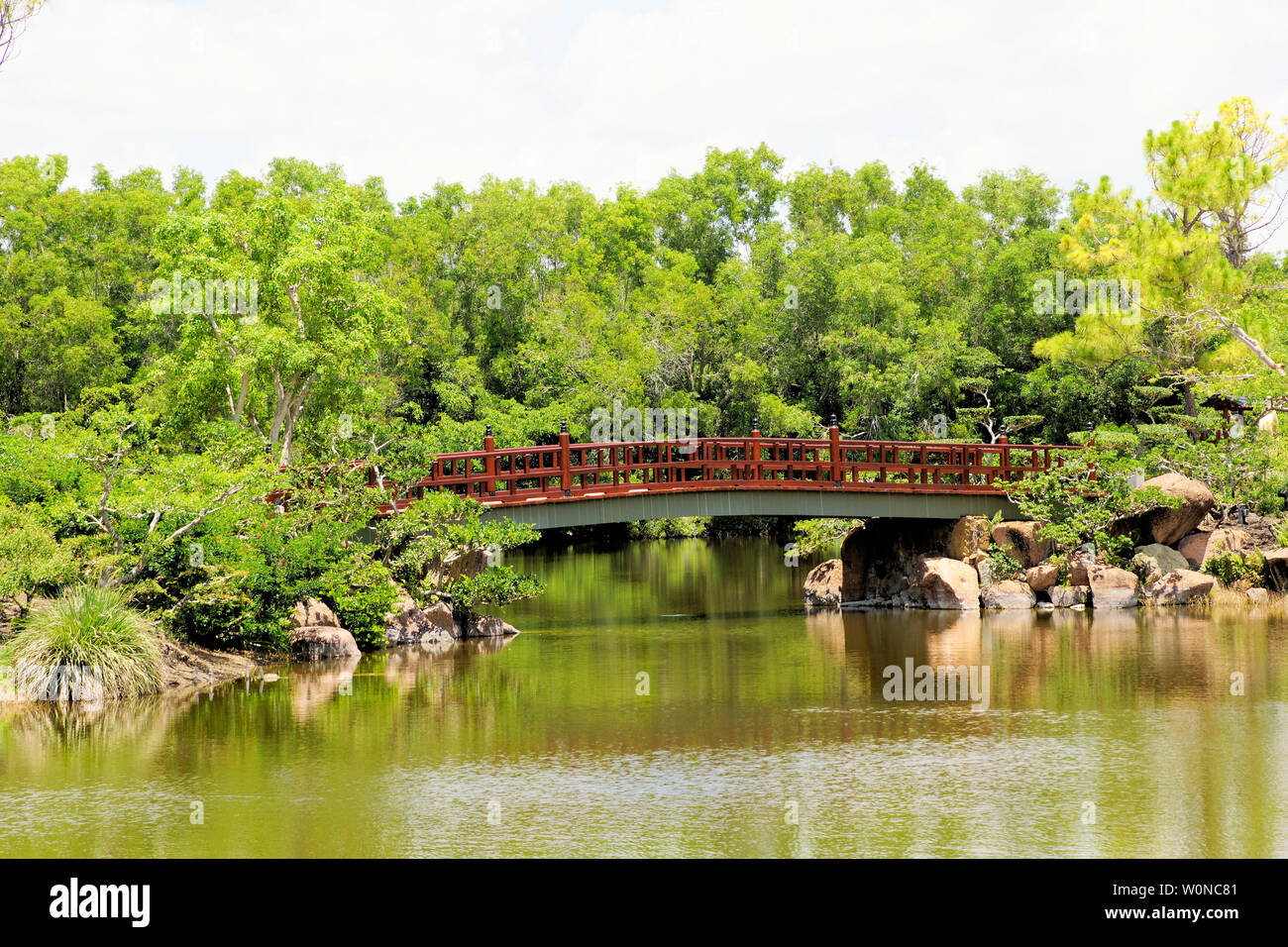 Delray Beach, Florida, Morikami Japanese Botanical Garden, beautiful bridge, waterfall and walkway along the lake among a lush foliage backdrop Stock Photo