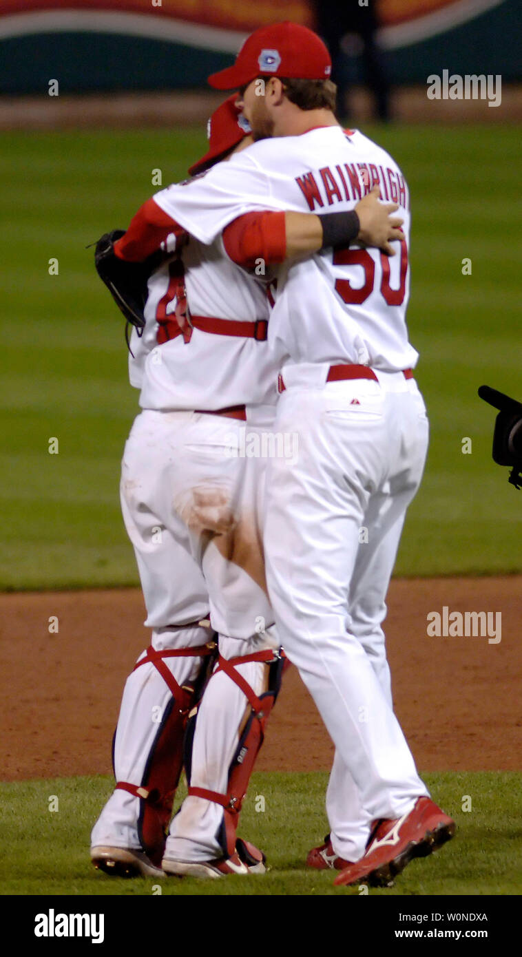 St. Louis Cardinals pitcher Adam Wainwright (50) and catcher Yadier Molina  (4) hug after defeating the Detroit Tigers 5-4 in game 4 of the World  Series at Busch Stadium in St. Louis