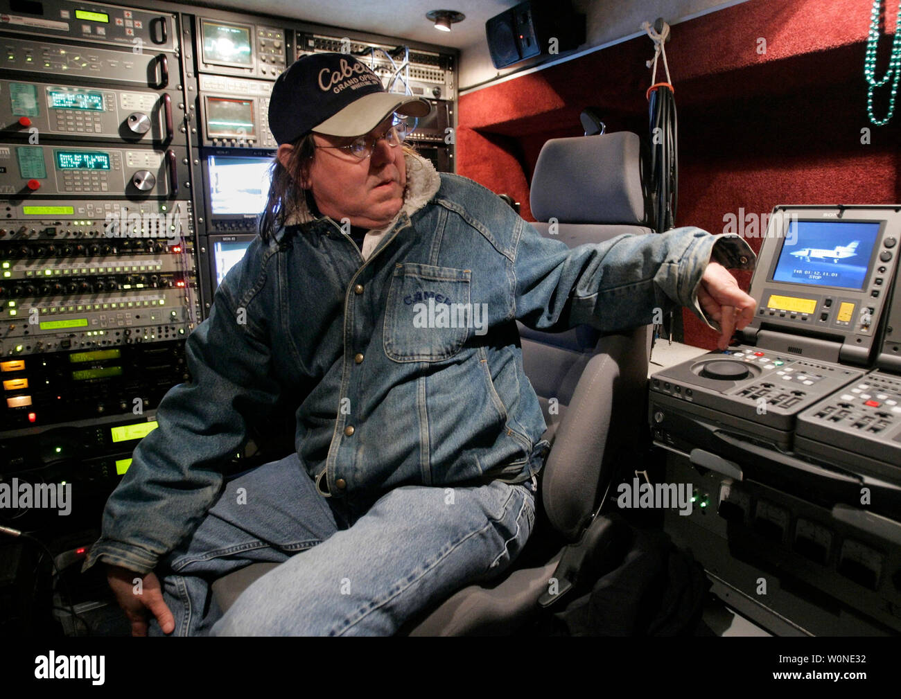 Engineer Brian McConnaughey handles the live truck operations for ABC News following Martha Stewart's release from prison on Friday, March 4, 2005 at the Greenbrier Valley Airport in Lewisburg, West Virginia.  Stewart boarded a plane bound for Bedford, New York (shown on the monitor) soon after being released from the Federal Prison Camp in Alderson, West Virginia at 12:30 a.m. EST.  (UPI Photo/Billy Suratt) Stock Photo