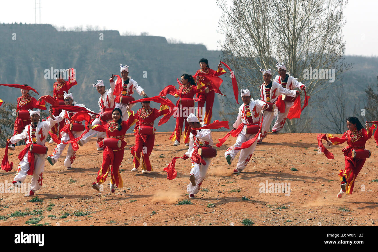 Chinese from surrounding villages perform the famous Ansai Waist Drum Dance  in its birthplace Ansai County, Shaanxi Province on April 7, 2017. The  dance is a unique, large-scale folk dance wth a