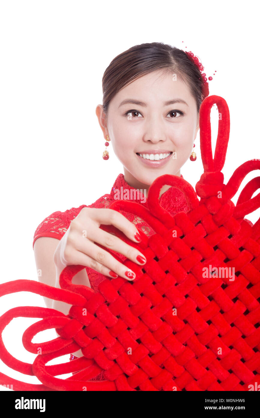 young asian woman in red cheongsam holds red chinese knot in chinese new year Stock Photo