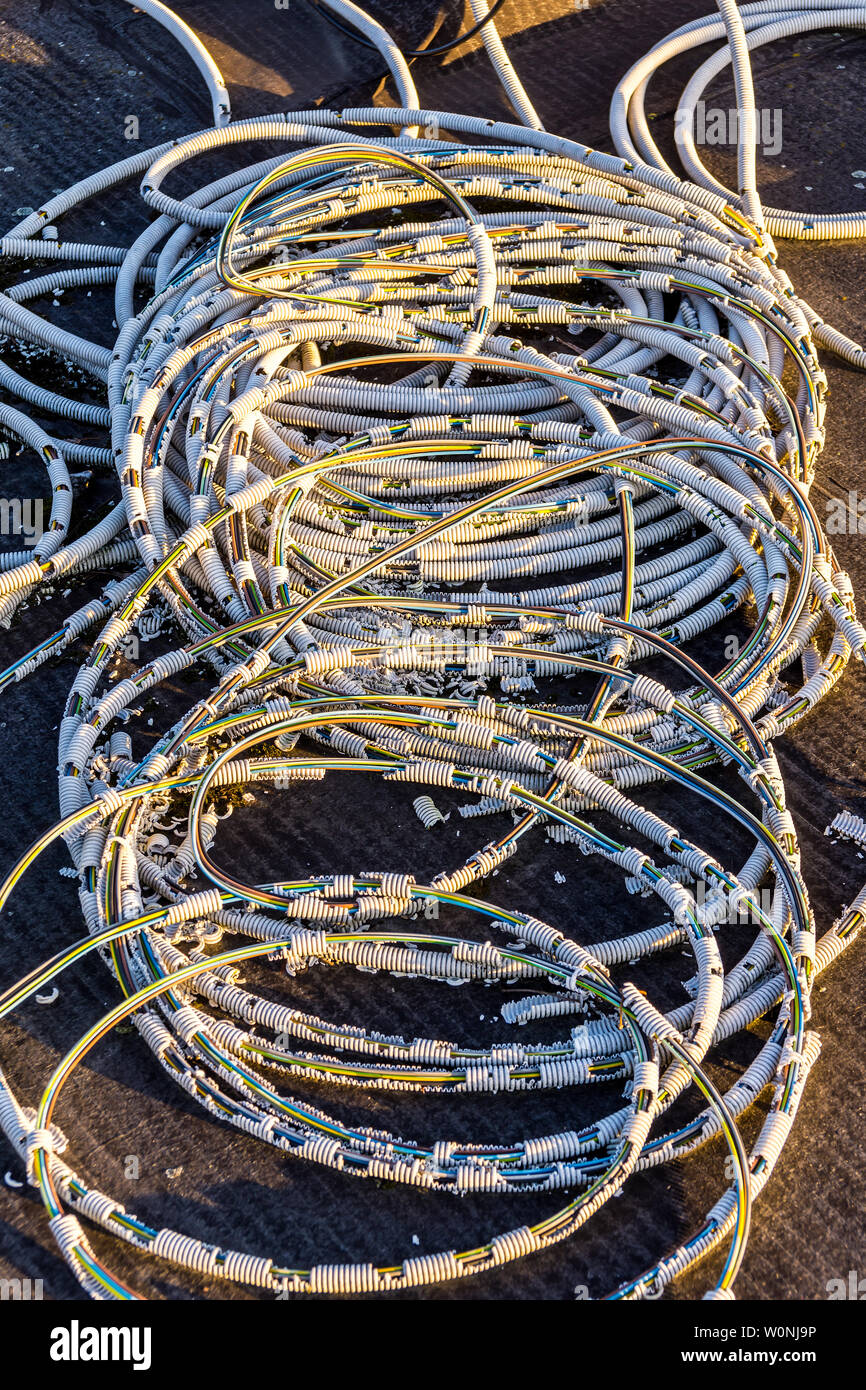 Old corroded flexible plastic conduit for electrical wiring. Stock Photo