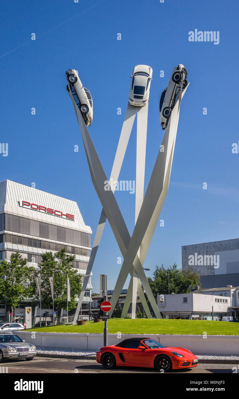 Porsche sculpture on Porscheplatz in Stuttgard-Zuffenhausen at the Porsche Museum, Porsche 911 models striving upwards on three steles, Stuttgart, Ger Stock Photo