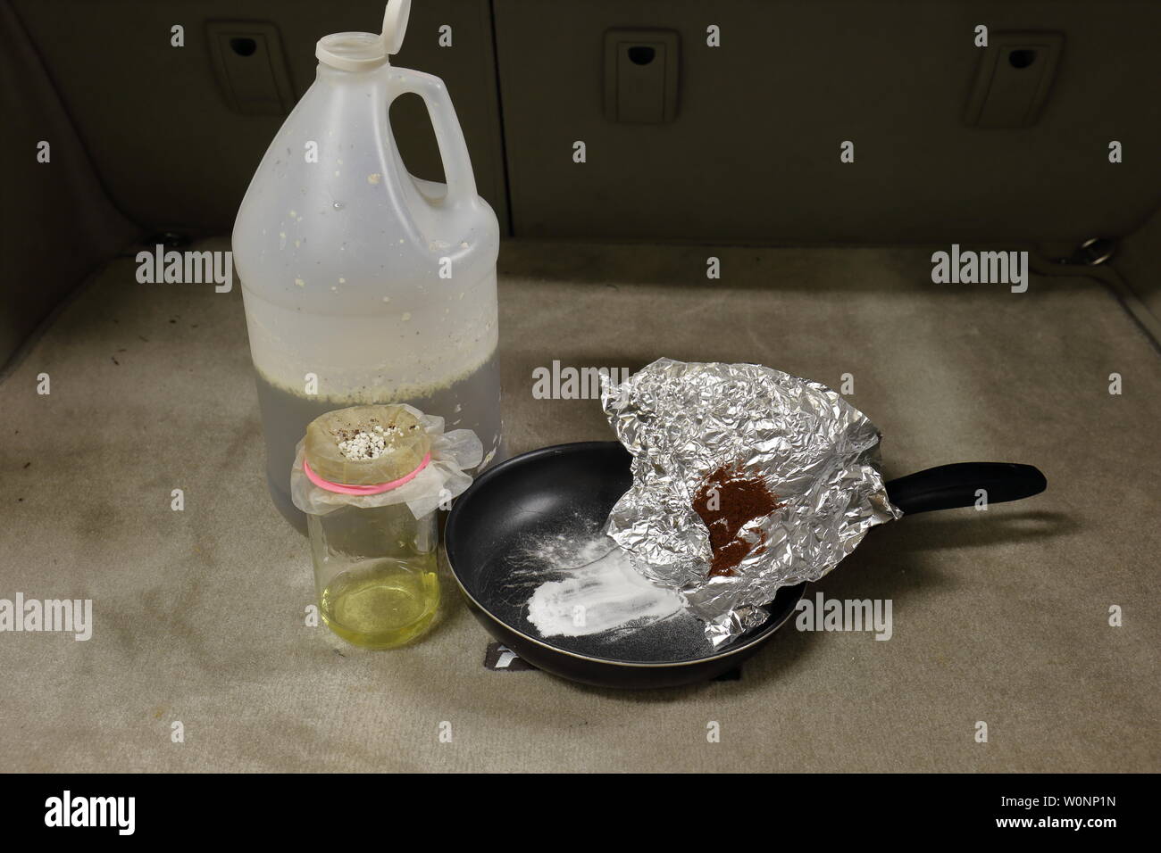 Supplies and chemicals used to manufacture methamphetamine in the back of a vehicle; illustrates the 'shake-n-bake' method Stock Photo
