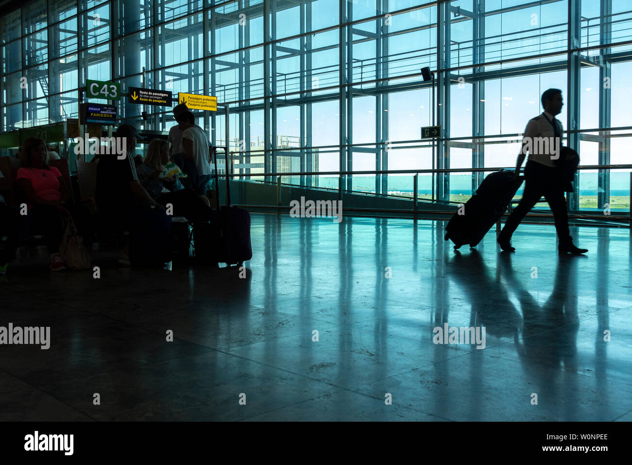 Silhouette of Passengers at Departure Terminal in Alicante International Airport Stock Photo