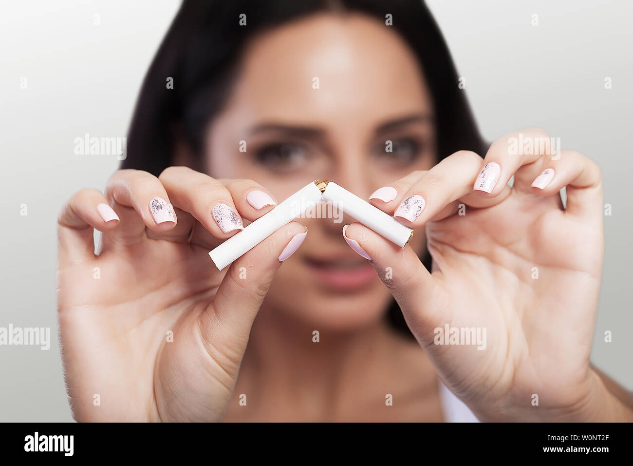 Smoking. Break the cigarette in half. Smoking is prohibited. The concept of health care. Young