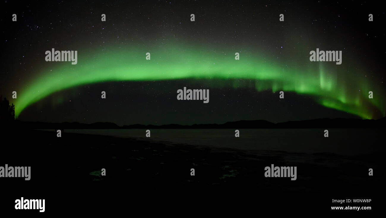 Aurora Borealis or Northern Lights from the shores of Lake Laberge north of Whitehorse, Yukon, Canada Stock Photo