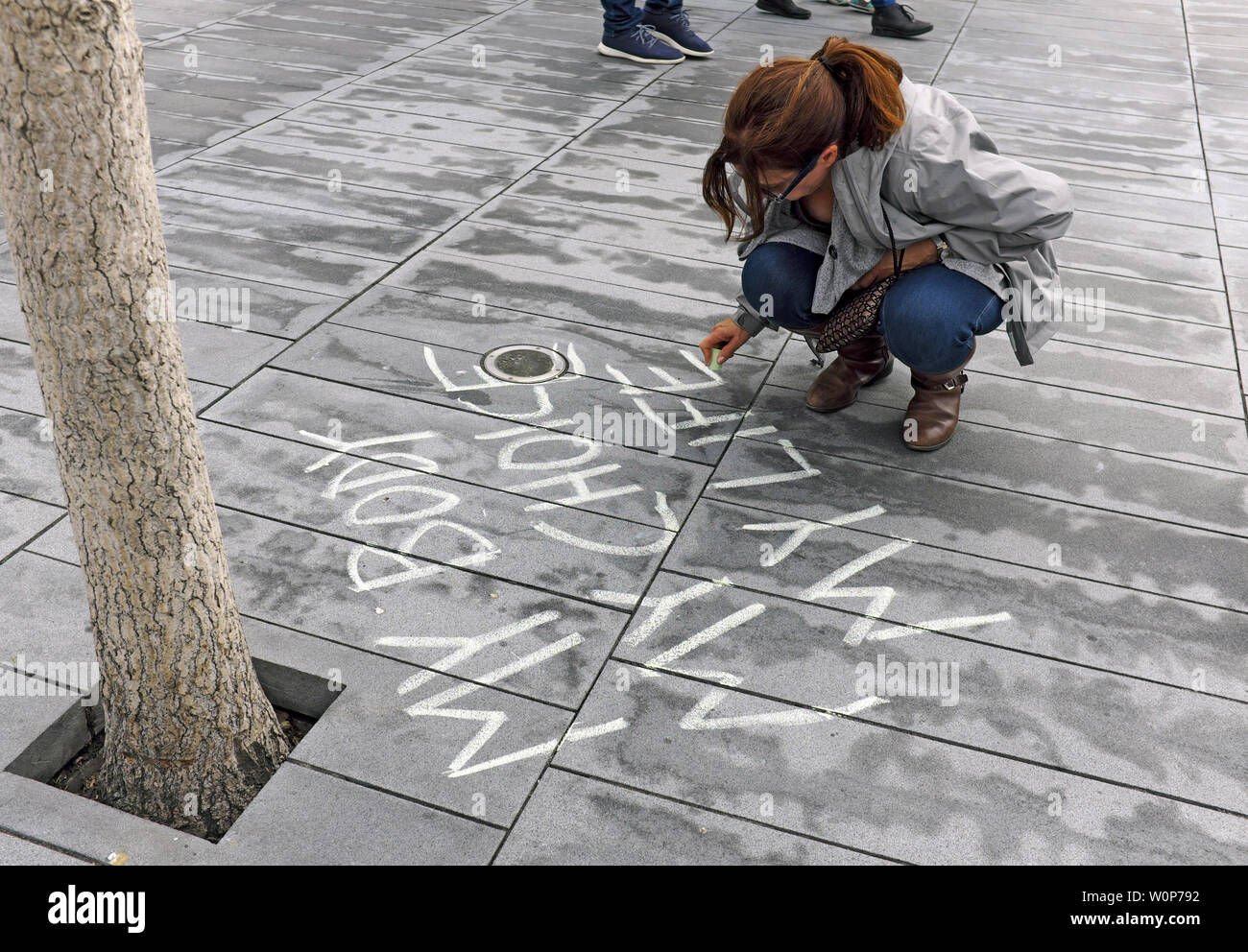'My Body, My Choice, My Life' is chalked by a woman participating in a 2019 Women's Rights rally in Cleveland, Ohio, USA. Stock Photo