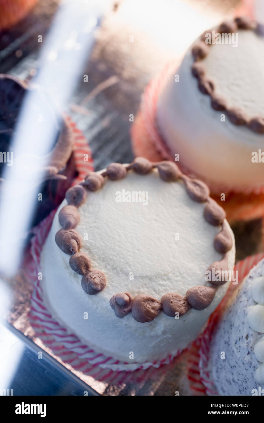 cakes in a display case in a bakery Stock Photo Alamy