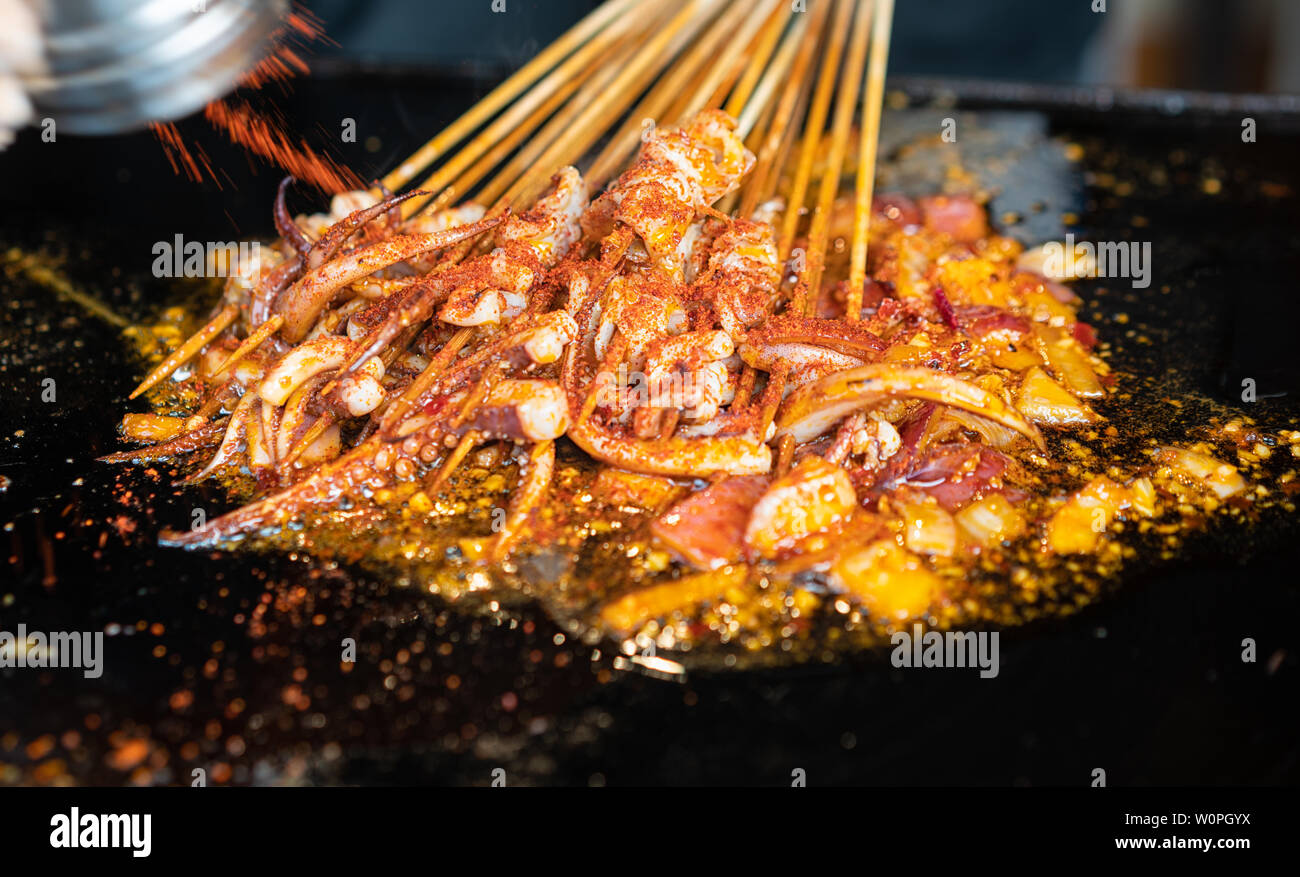 Baked squid in the making Stock Photo