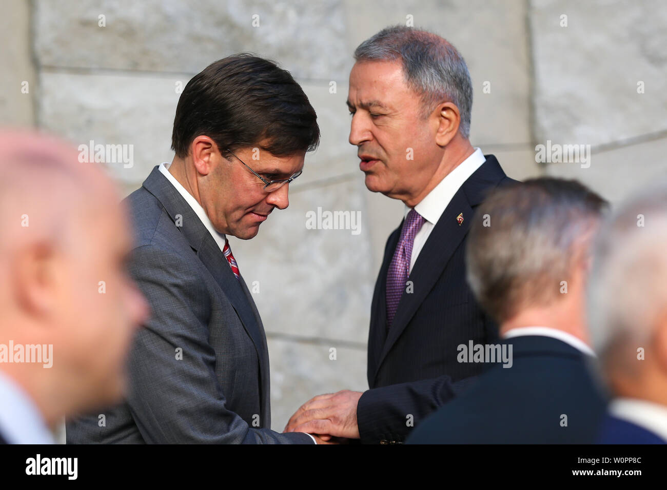 Brussels, Belgium. 27th June, 2019. U.S. Acting Secretary of Defense Mark Esper (L) chats with Turkish Defense Minister Hulusi Akar while attending a NATO defense ministers meeting at NATO headquarters in Brussels, Belgium, on June 27, 2019. The two-day NATO defense ministers meeting closed on Thursday. Credit: Zhang Cheng/Xinhua/Alamy Live News Stock Photo