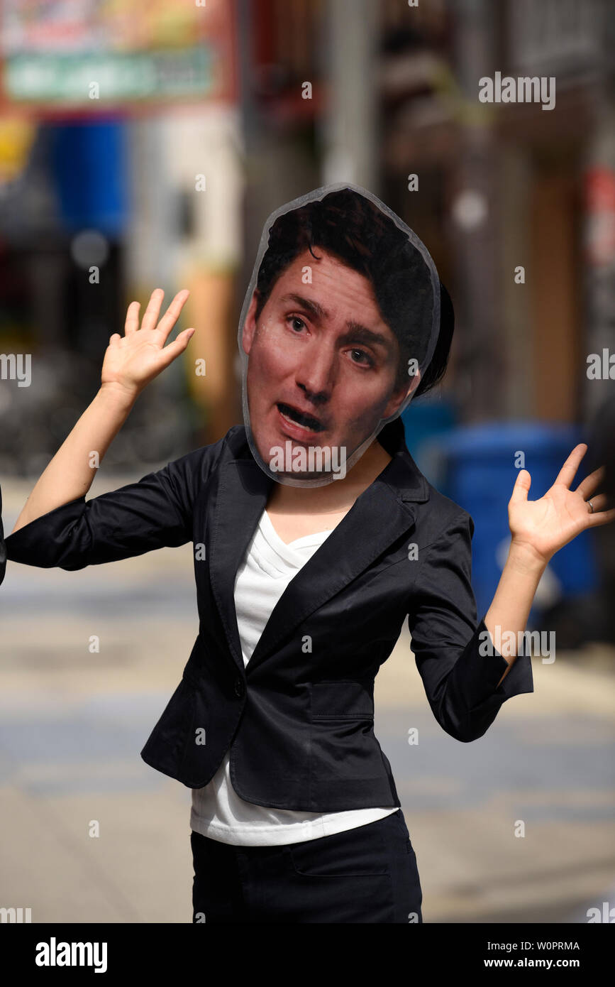 Osaka, Japan. 28th June, 2019. A protestor wears a mask of Canadian Prime Minister Justin Trudeau at a protest against coal power during the G20 Summit in Osaka, Japan. Credit: Ben Weller/AFLO/Alamy Live News Stock Photo