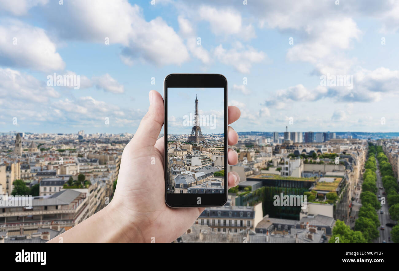 Hand taking photo of Eiffel tower, famous landmark and travel destination in Paris, France by mobile smart phone Stock Photo