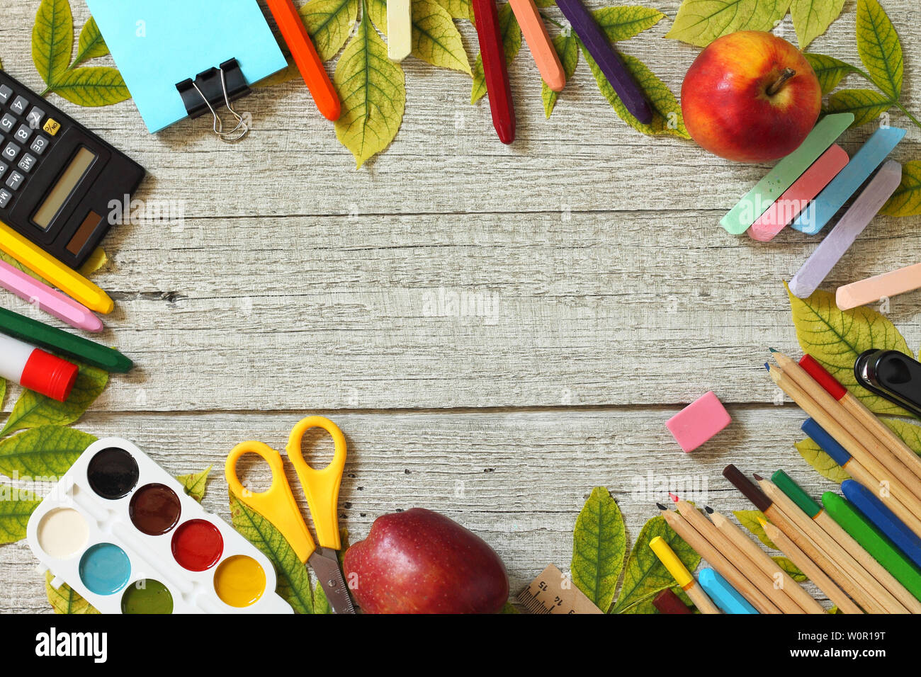 Back to school background. Table with apple, different school supplies,  stationery, pencils. Flatlay top view. Free space for your text Stock Photo  - Alamy