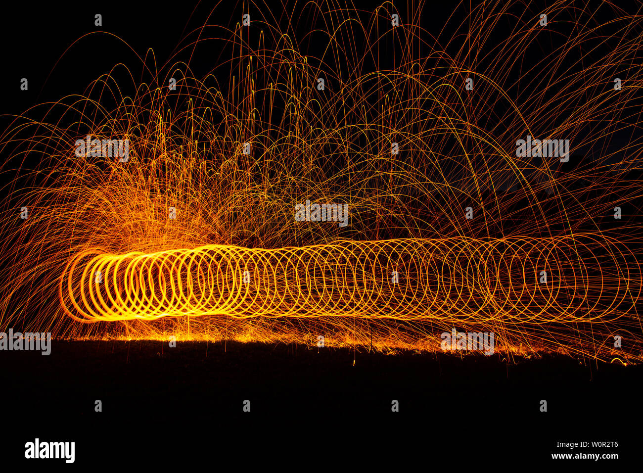 Firescape night photography. Having fun creating art with wire wool and fire at night. Stock Photo