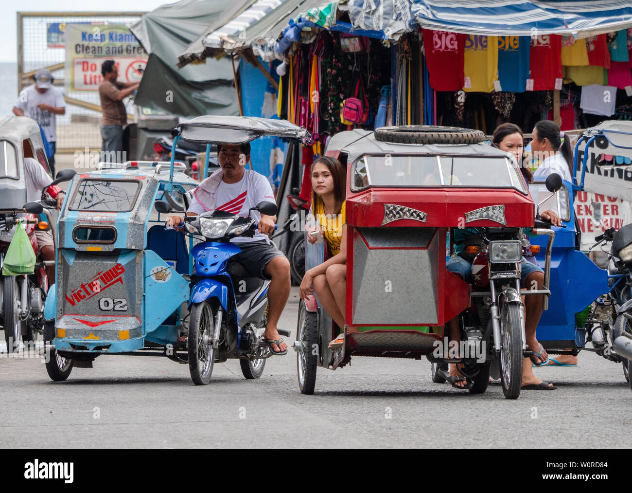Tricycle taxis in Kiamba, a popular tourist destination in the Sarangani province on Mindanao, the Philippines. Stock Photo