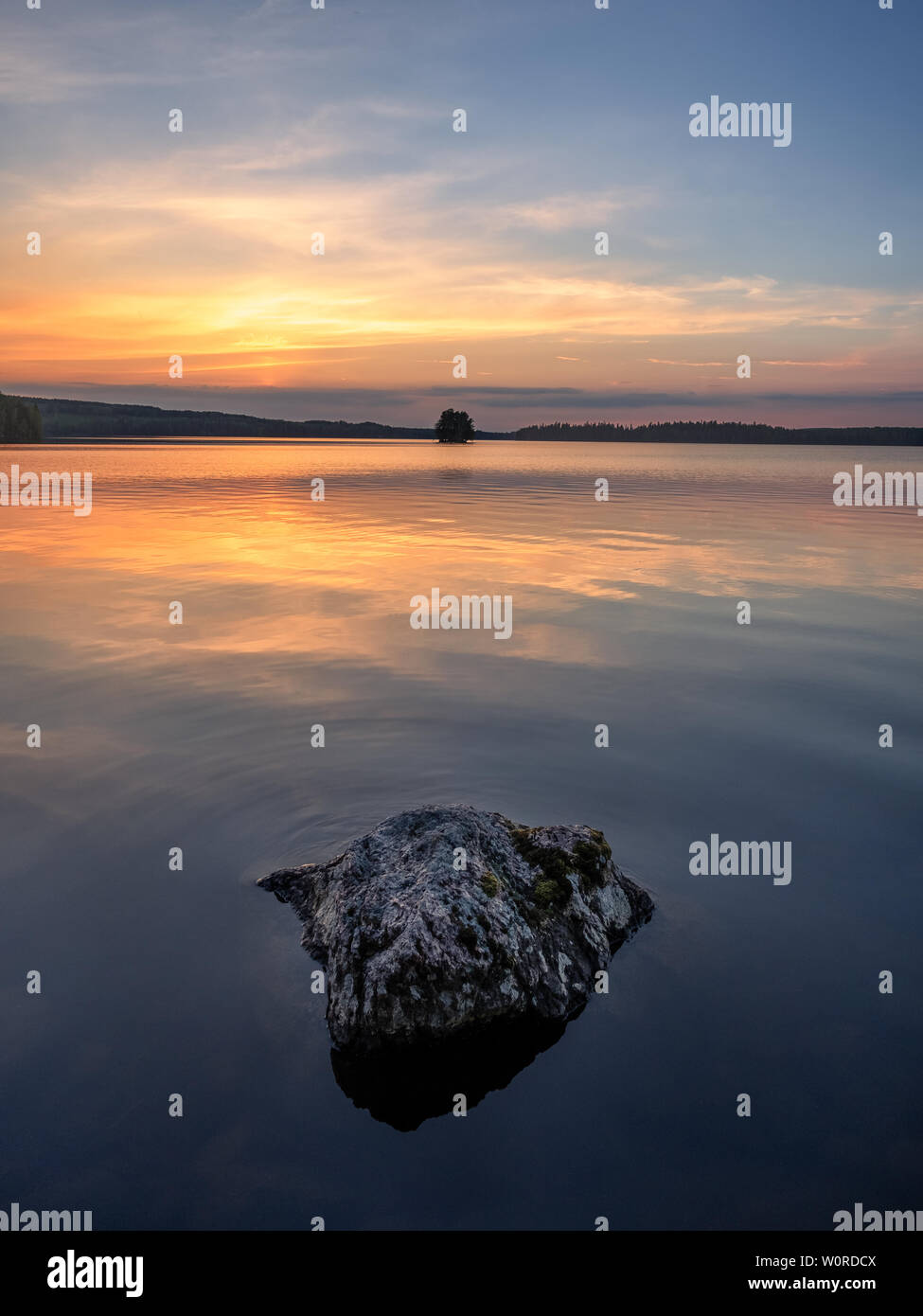 Scenic landscape with beautiful sunset and lake at summer evening in Finland Stock Photo