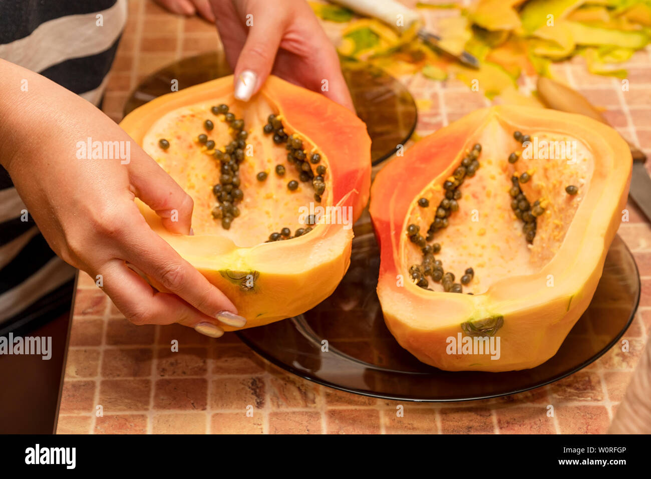 Cut into two parts papaya fruit with seeds. Papaya cut in half Stock