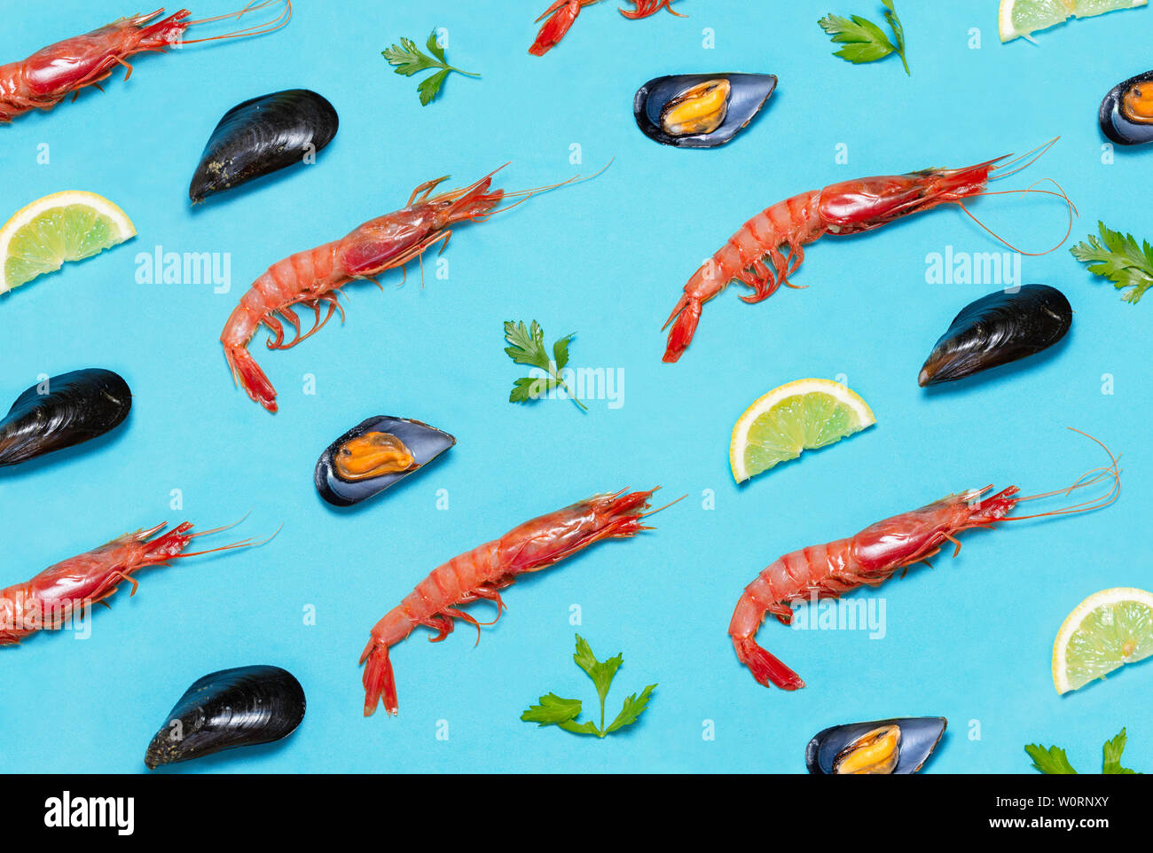 prawns mussels patterns tapas mediterranean vermouth, repetitions of seafood products on blue background Stock Photo