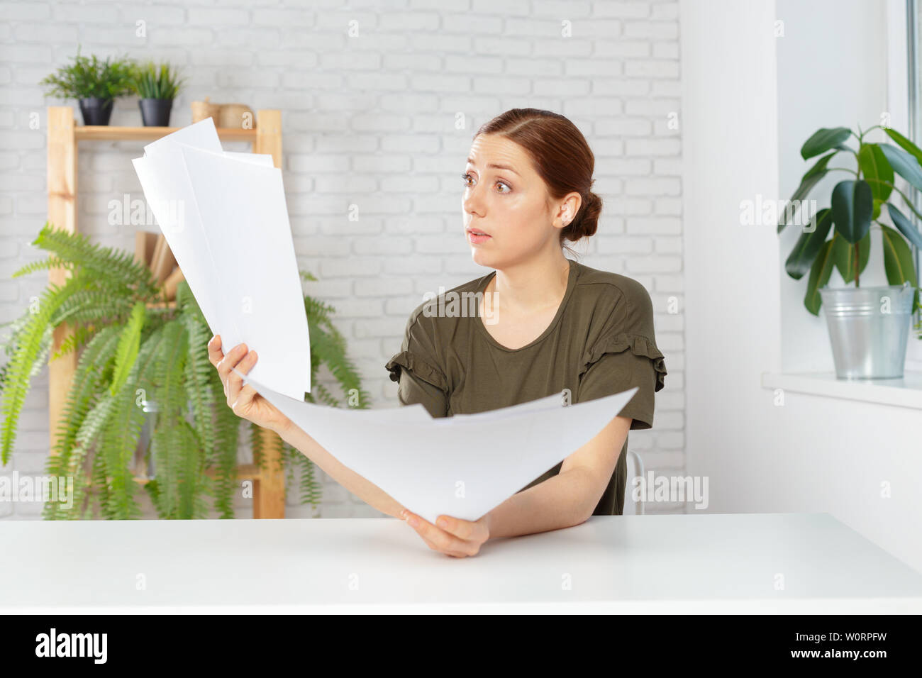 Female office workers holding are arranging documents of unfinished documents on office desk Stock Photo