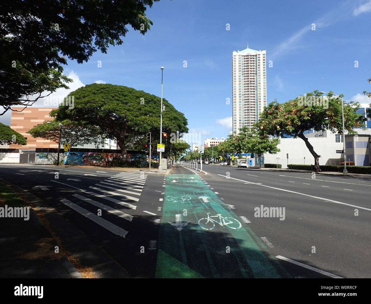 Honolulu - August 6, 2017: Green Painted King Street Protected Bike Lane intersecting roads in Downtown Honolulu. Stock Photo