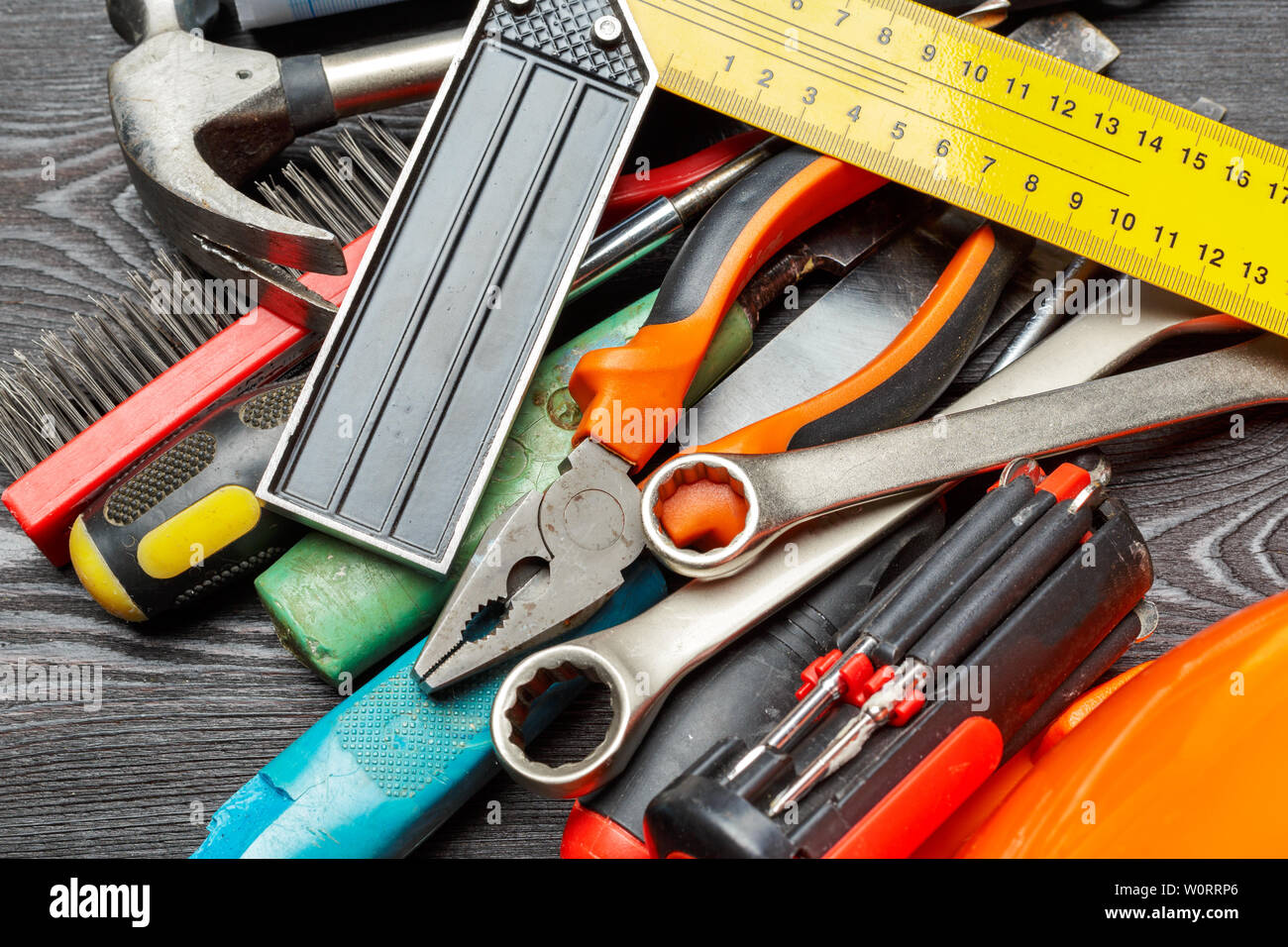 Assorted work tools on wooden table Stock Photo