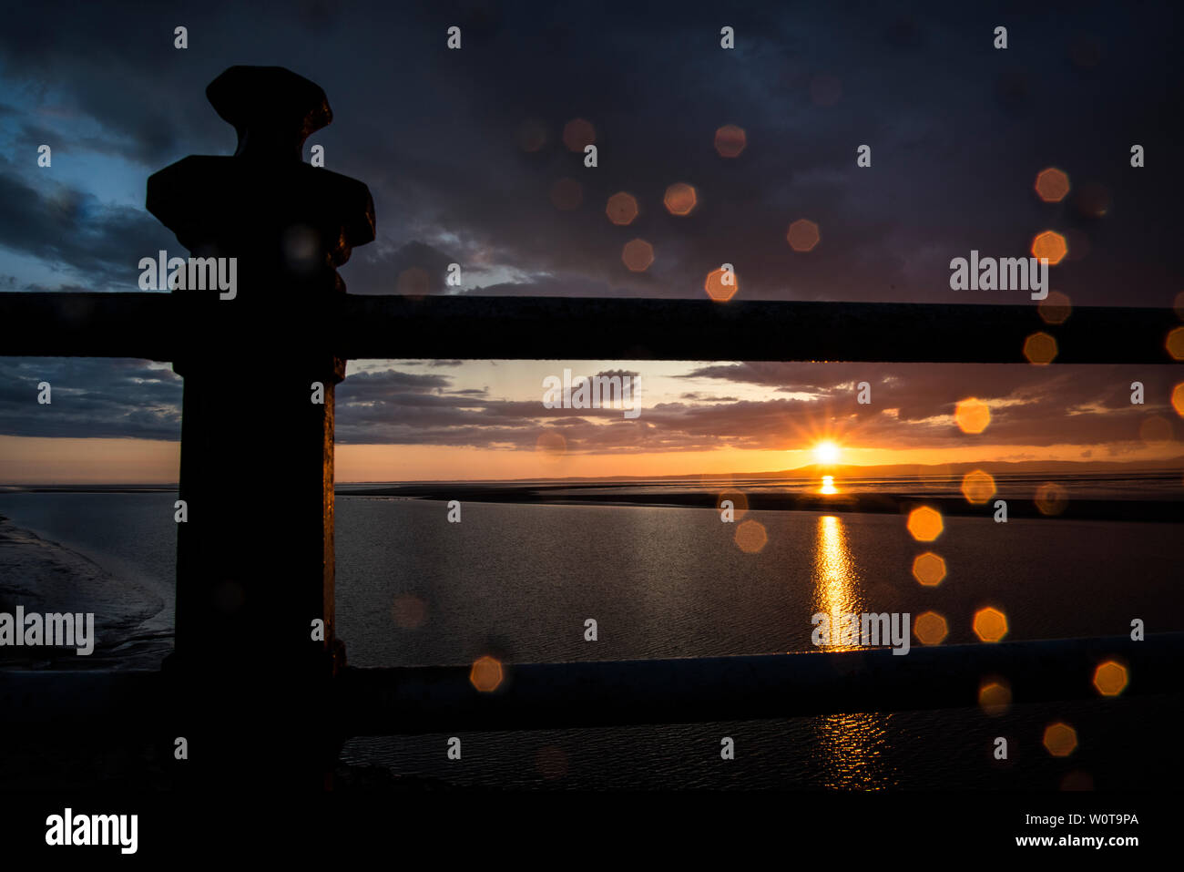 Stormy sunset at Morecambe Bay, bright lights and Bokeh through the